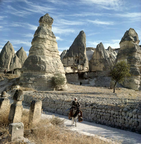 Cone dwellings at Macan, and farmer on donkey, Cappadocia, Turkey